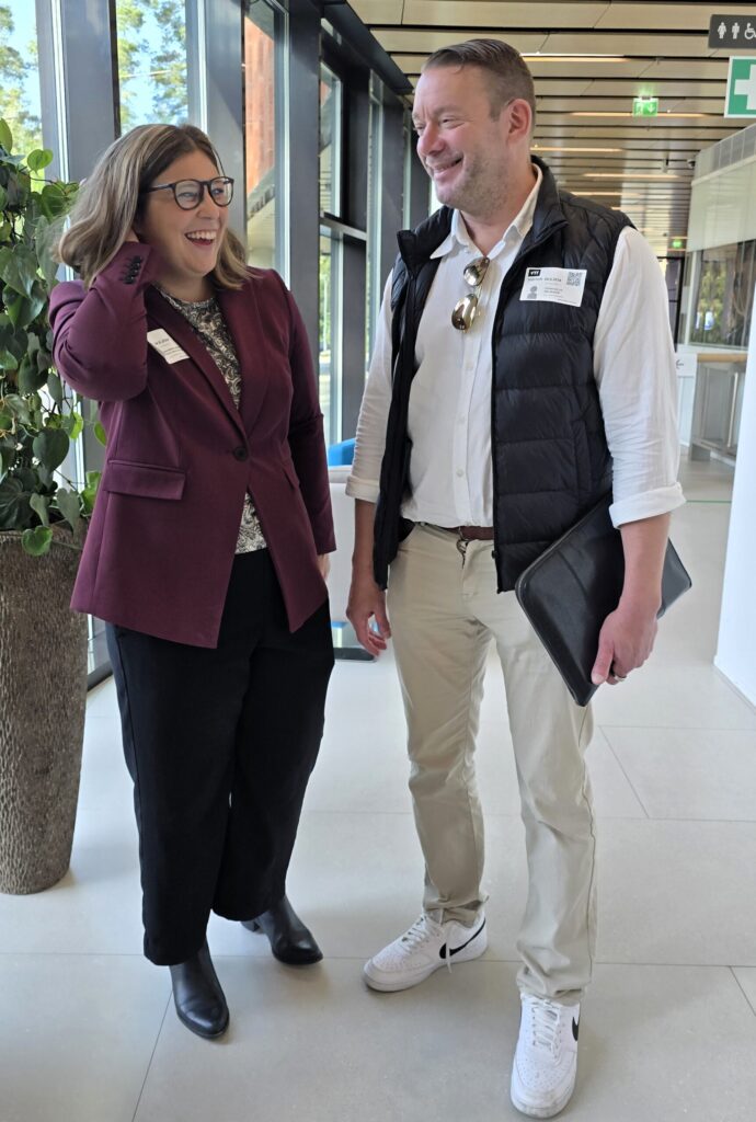 A woman and a man standing and conversating.